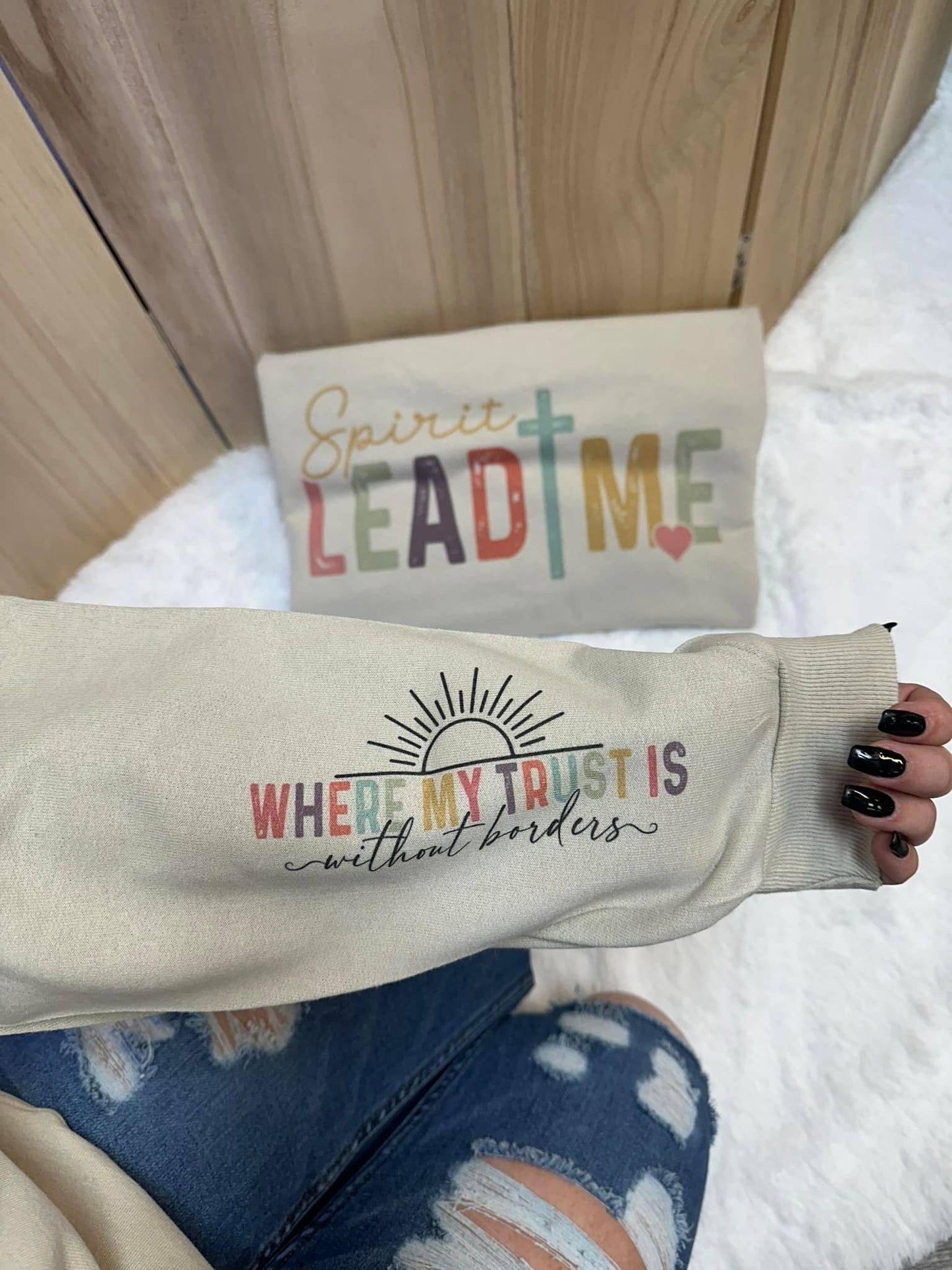 A unisex sweatshirt with the text 'Spirit Lead Me' printed on the front and a smaller text on the sleeve that reads 'Where my trust is without borders.'.