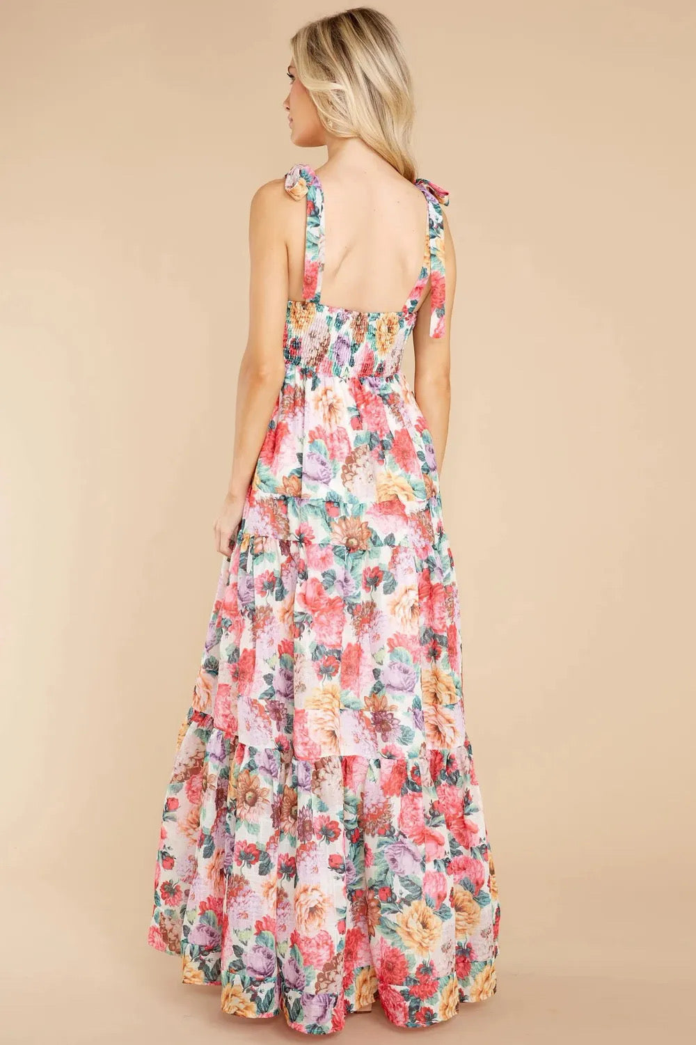 A floral square neck maxi dress with tie sleeves and a tiered skirt.