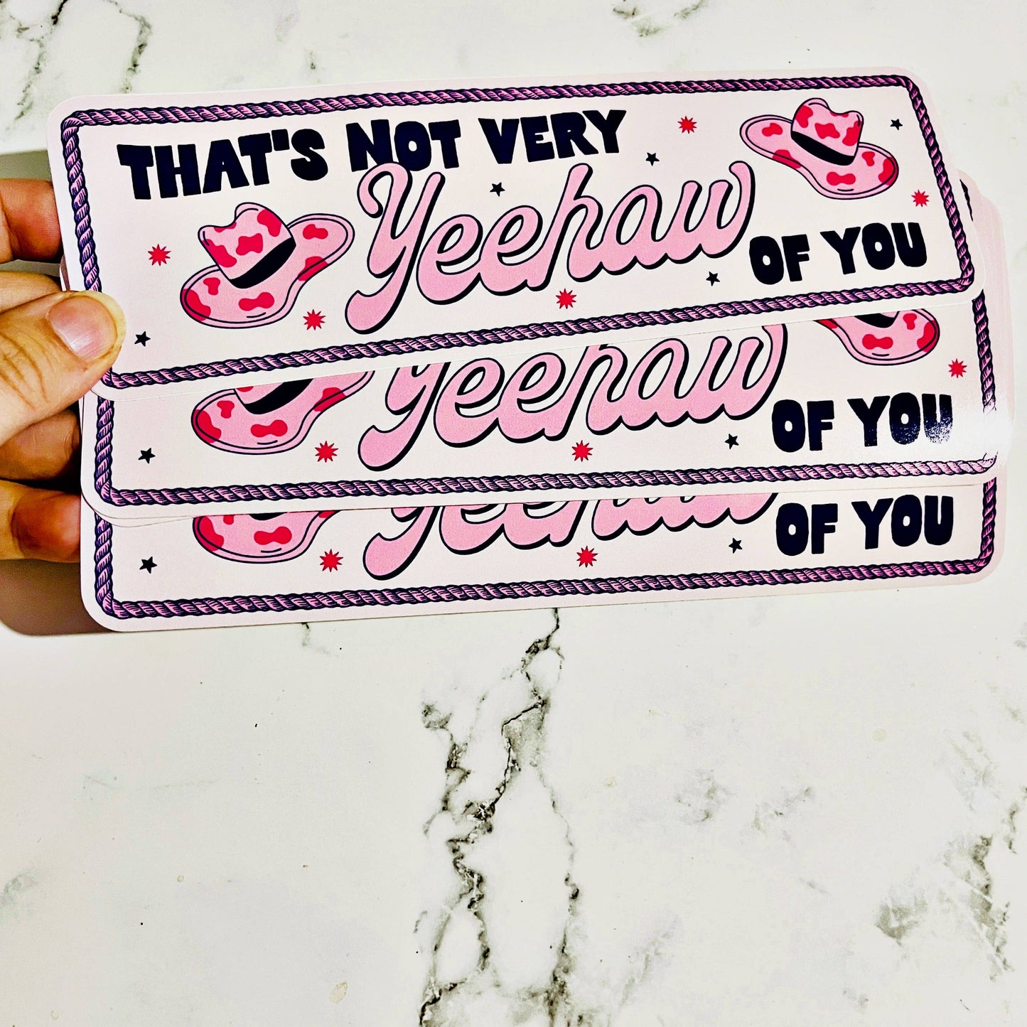 vinyle decal that says that's not very yeehaw of you in pink white and black color scheme