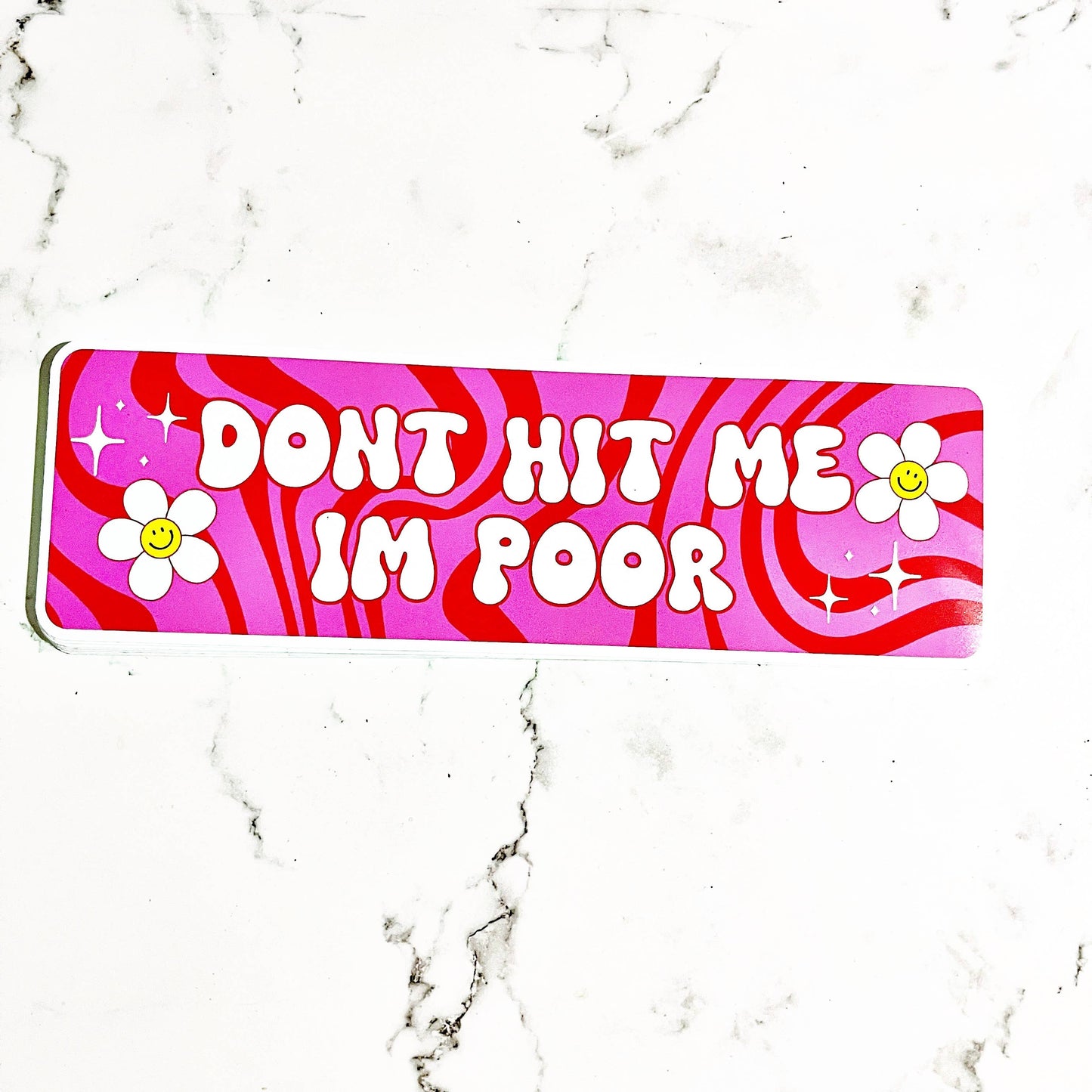 A vinyl decal with pink background and white text that reads 'DON'T HIT ME I'M POOR' repeated three times, surrounded by white stars and stripes pattern.