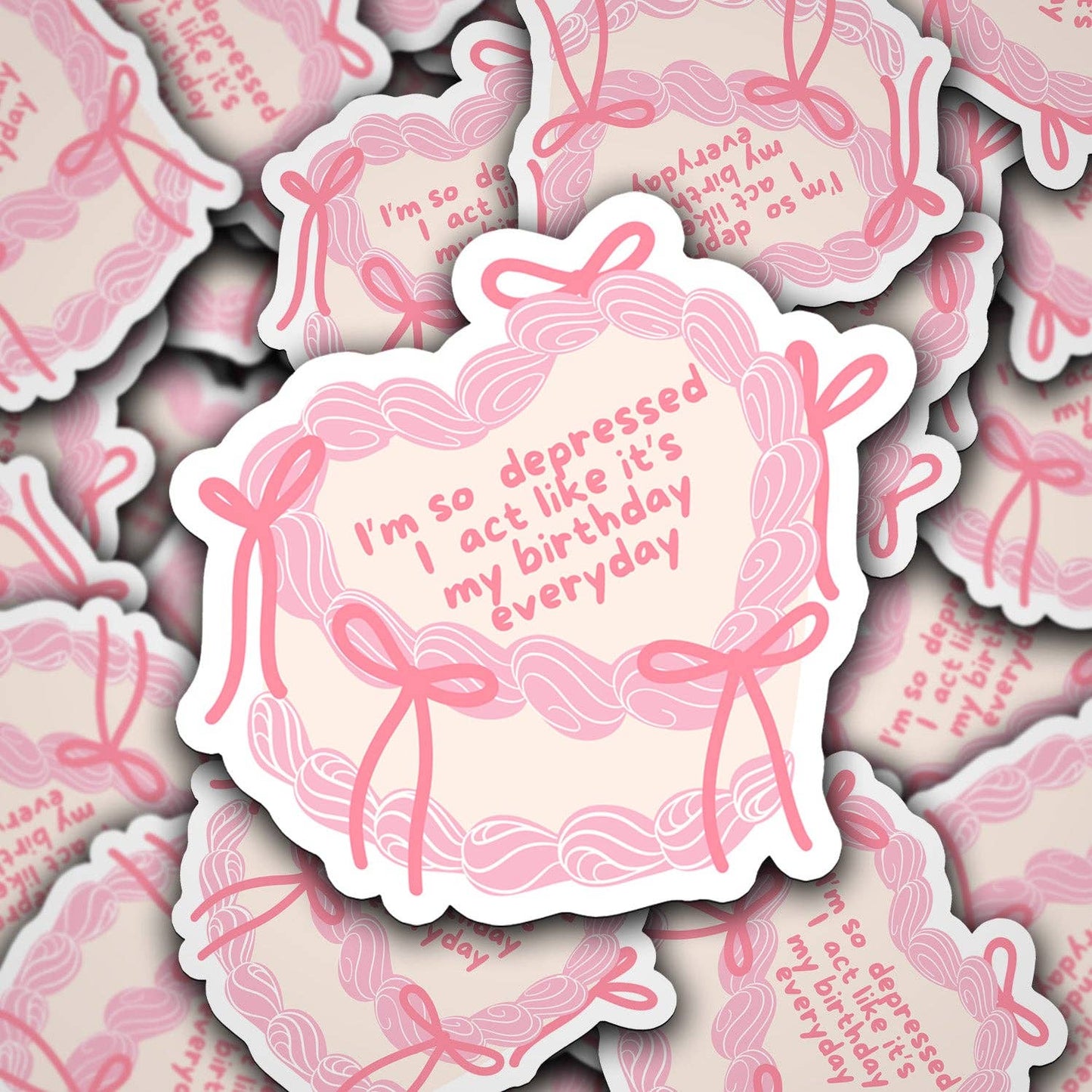 A vinyl decal with a pink and white design featuring text and decorative elements.