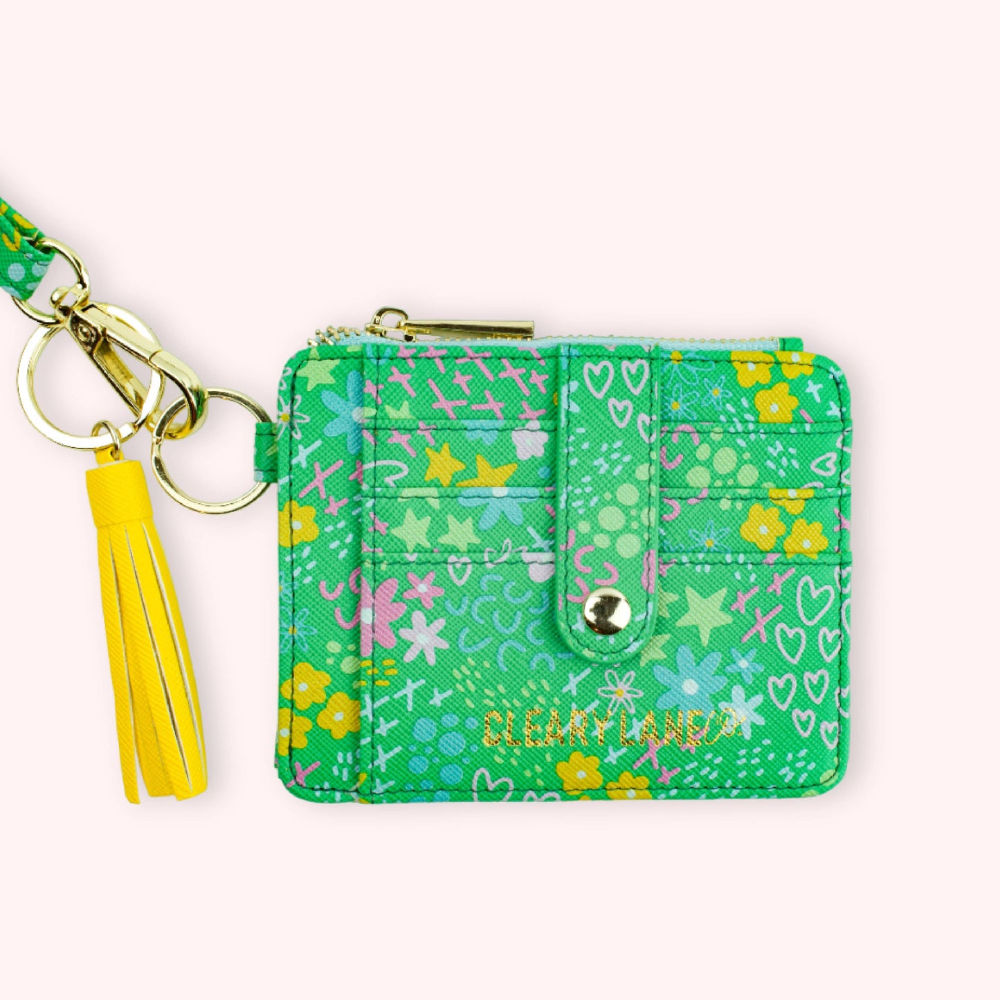 A green faux leather wallet keychain with a floral pattern with a key ring and strap attached.