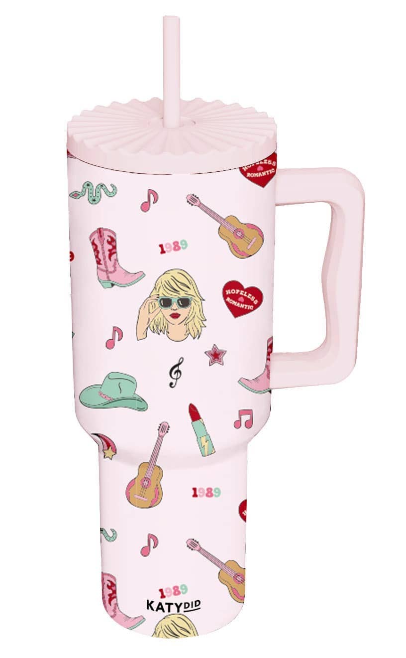 A pink stainless steel tumbler with musical themed graphics, including a guitar and headphones, and the brand name 'KATY DID' written on it.