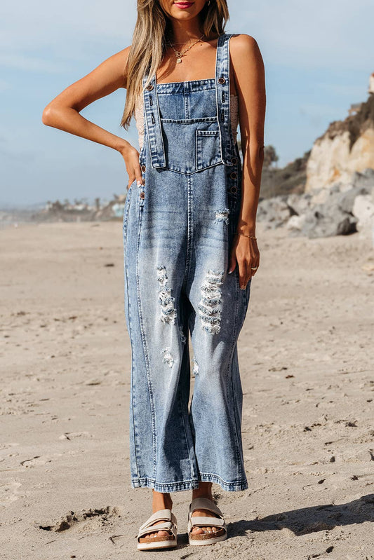 Woman wearing a denim overalls on a beach