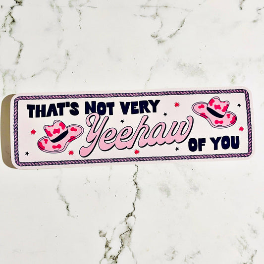 vinyle decal that says that's not very yeehaw of you in pink white and black color scheme