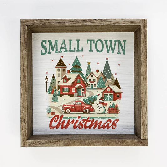 Framed Christmas-themed artwork with a small town scene and 'Small Town Christmas' text.