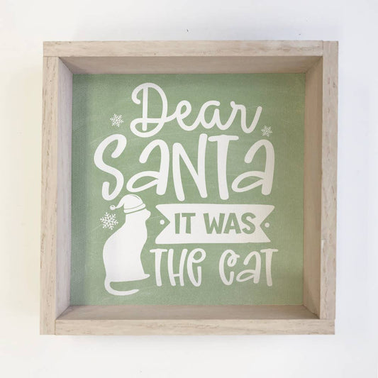 Framed sign with 'Dear Santa It Was The Cat' text on a green background