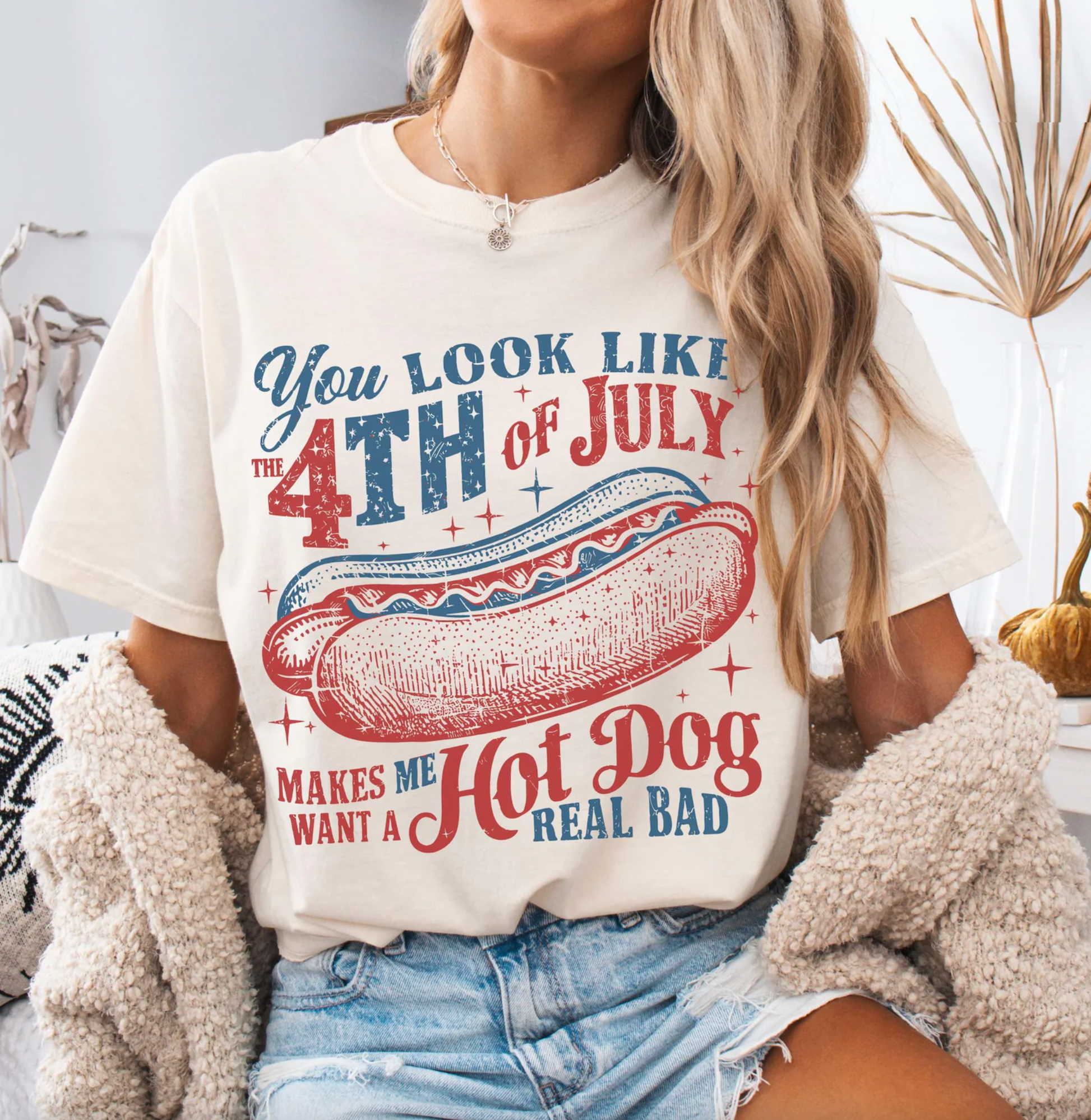Person wearing a t-shirt with a 4th of July graphic design.
