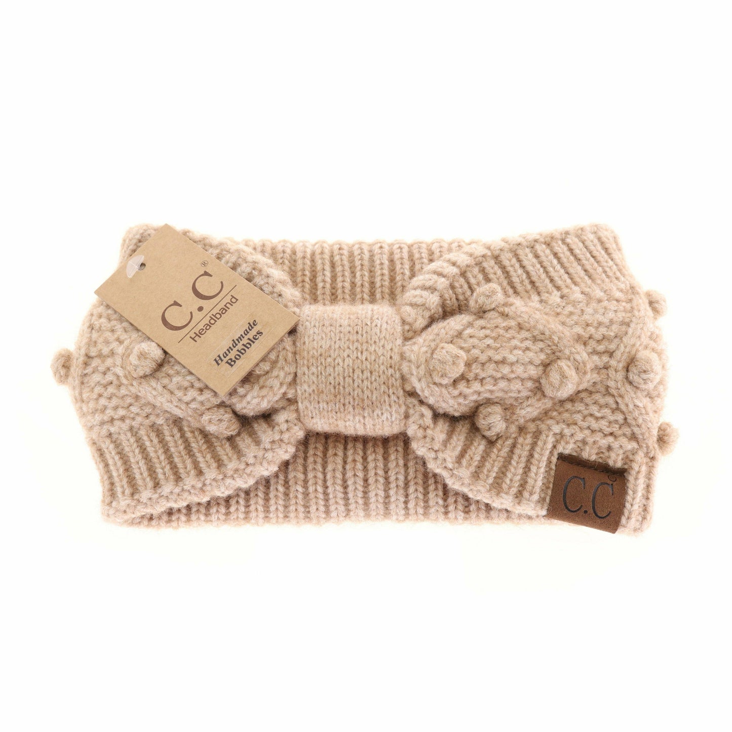 Knitted headband with a bow and CC tag on a white background