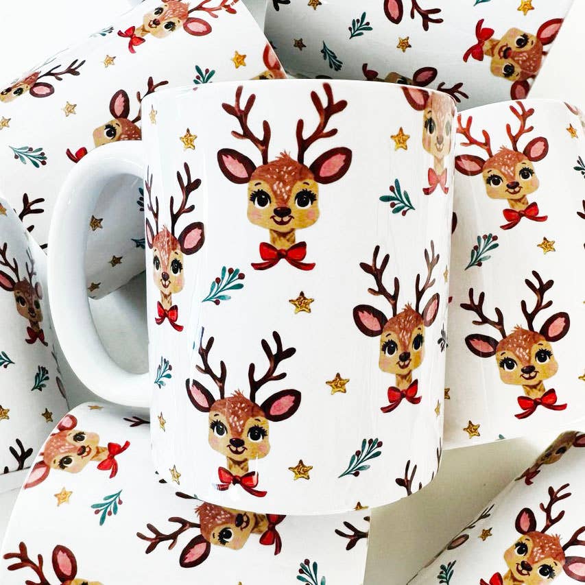 Ceramic mug with cartoon reindeer design on a white background