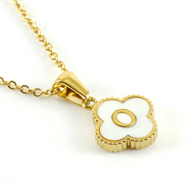 Gold necklace with a white clover-shaped pendant on a white background