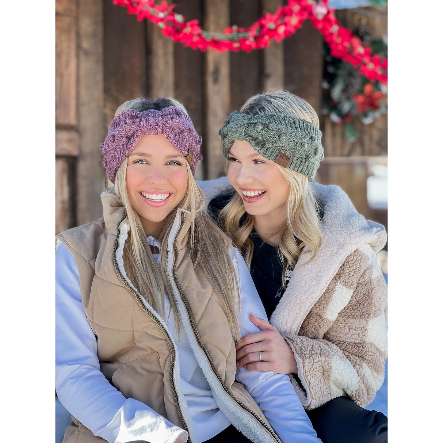 Two women wearing knitted headbands in a snowy outdoor setting.
