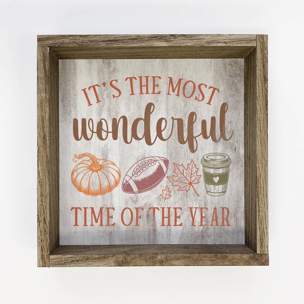 Decorative sign with autumn-themed elements and text in a wooden frame.