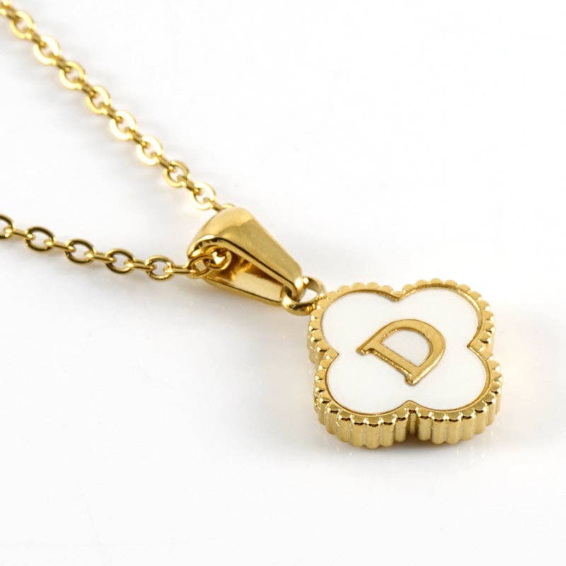 Gold necklace with a clover-shaped pendant featuring the letter 'D' on a white background