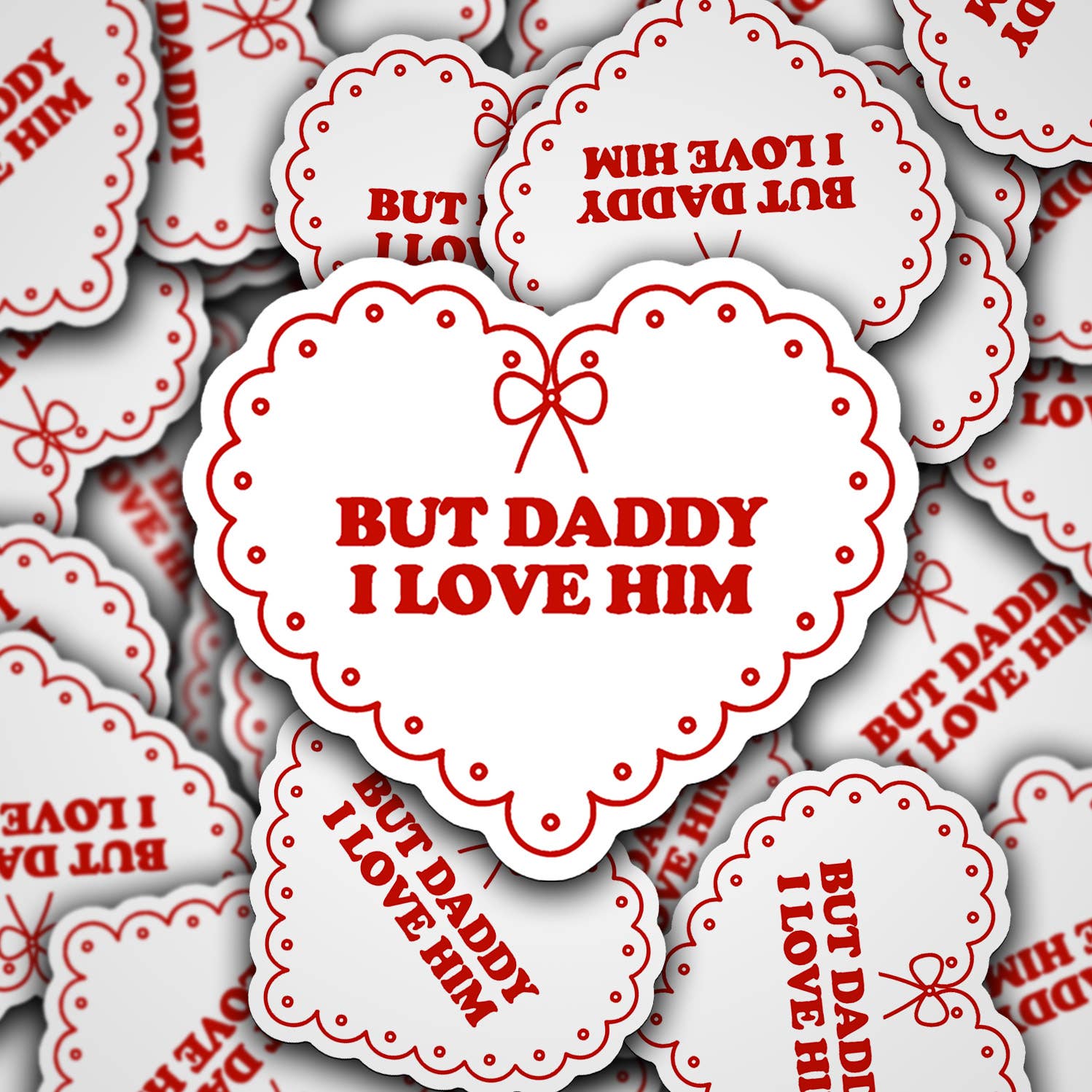 A collection of vinyl decals with the phrase 'BUT DADDY I LOVE HIM' printed in red on a white background, arranged in a collage pattern.
