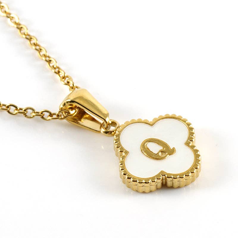 Gold necklace with a white pendant on a white background