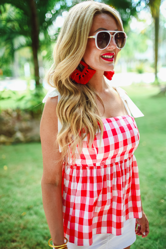 Woman wearing a red and white checkered top outdoors