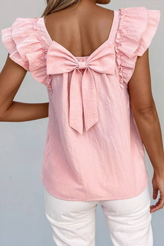 A pink blouse with ruffled sleeves and a bow knot at the back neckline, displayed on a model.