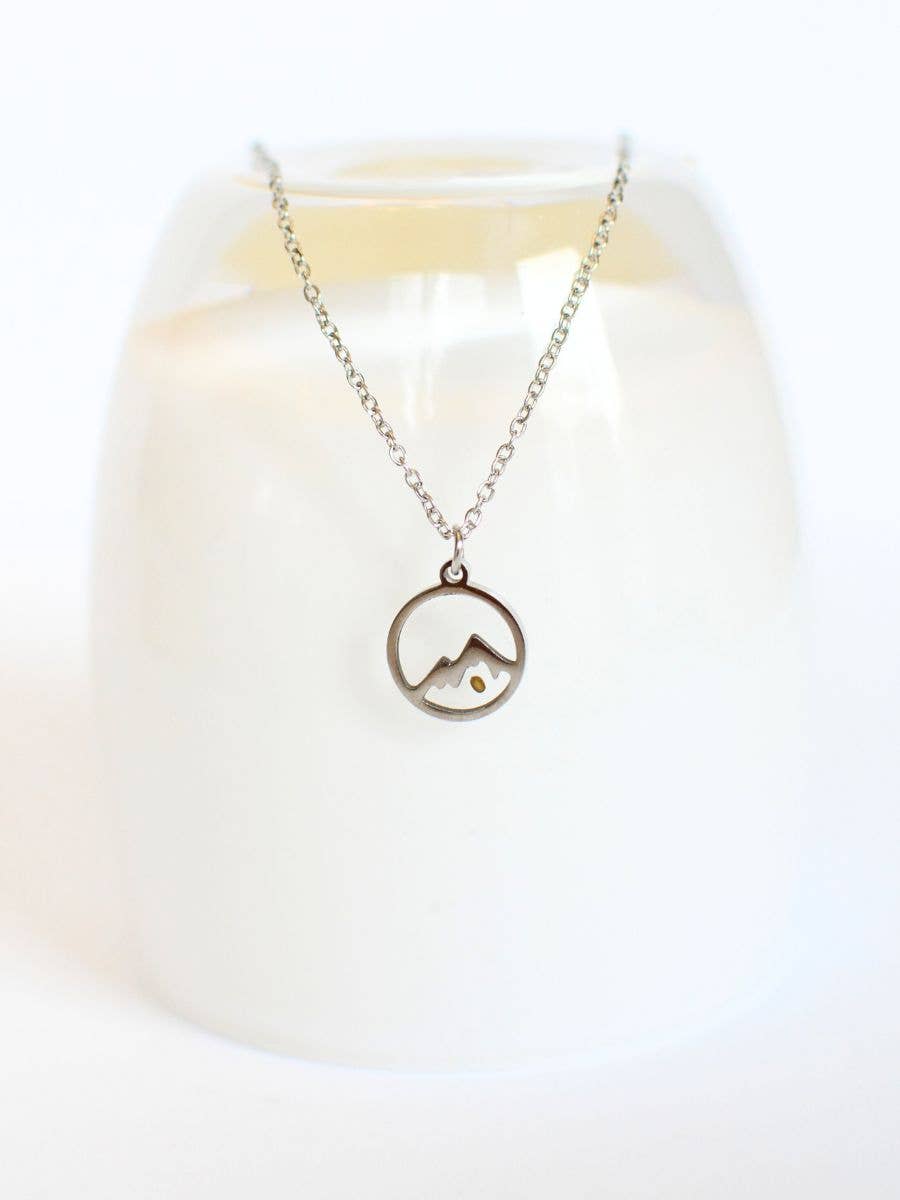 Necklace with a mountain pendant on a white background