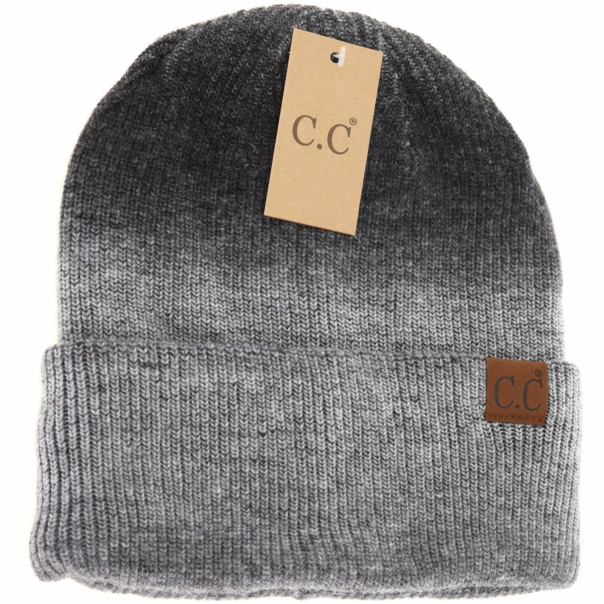Gray knit beanie with a brown tag and label on a white background