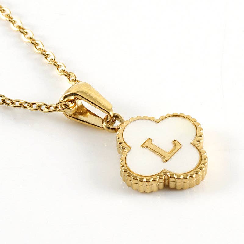 Gold necklace with a heart-shaped pendant featuring the letter 'L' on a white background