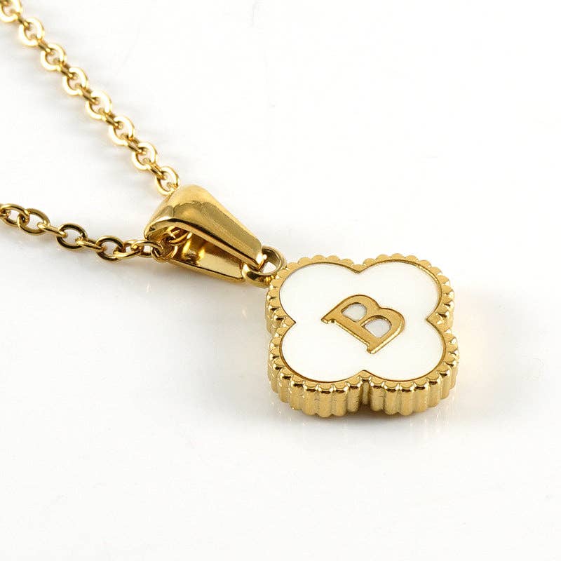Gold necklace with a heart-shaped pendant featuring the letter 'B' on a white background