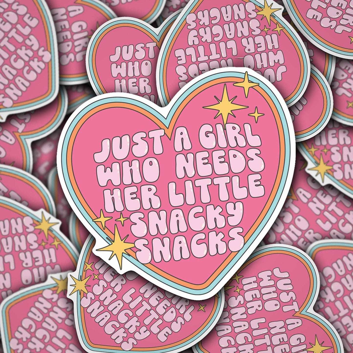 A collection of vinyl decals with various texts on them, featuring a prominent pink heart-shaped decal with the text 'JUST A GIRL WHO NEEDS HER LITTLE SNACKY SNACKS' in the center.