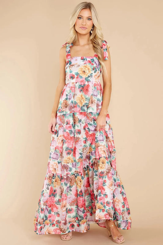 A floral square neck maxi dress with tie sleeves and a tiered skirt.