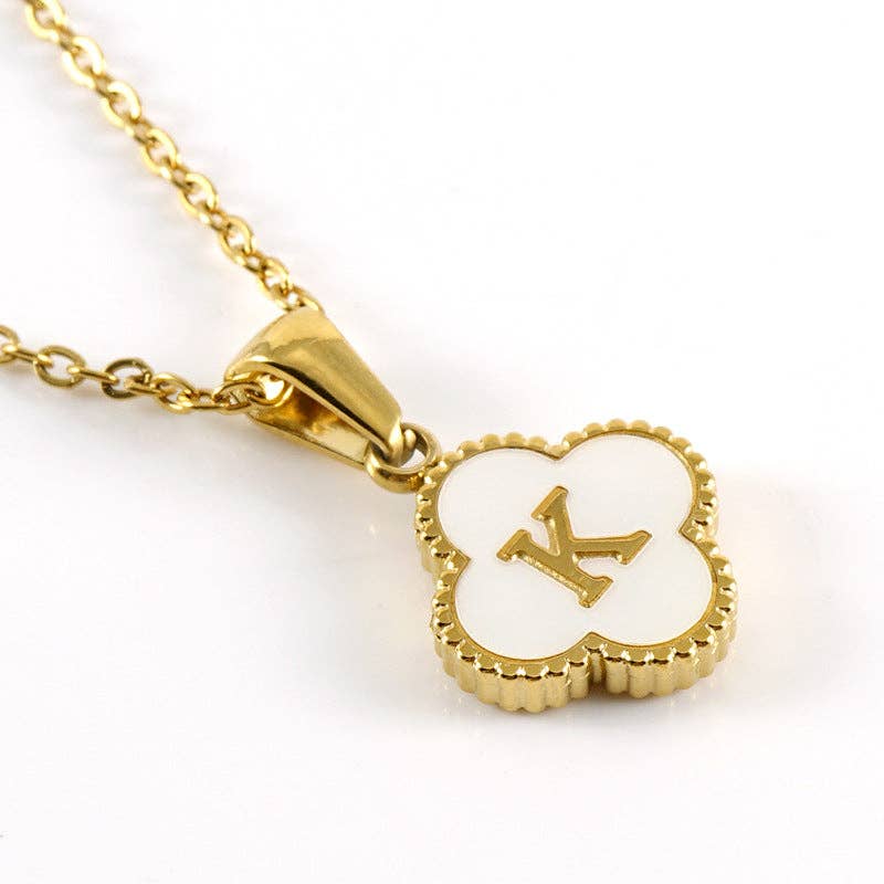 Gold necklace with a heart-shaped pendant featuring the letter 'K' on a white background