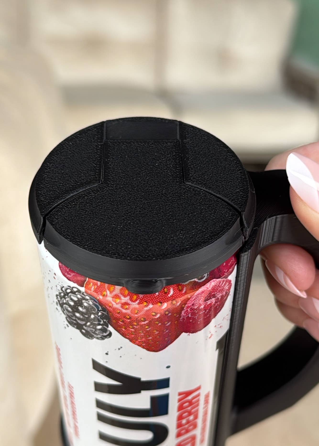 Close-up of a magenta-colored skinny can holder lid with a design that includes the text 'Hotline' and 'Chill', and a depiction of a can.