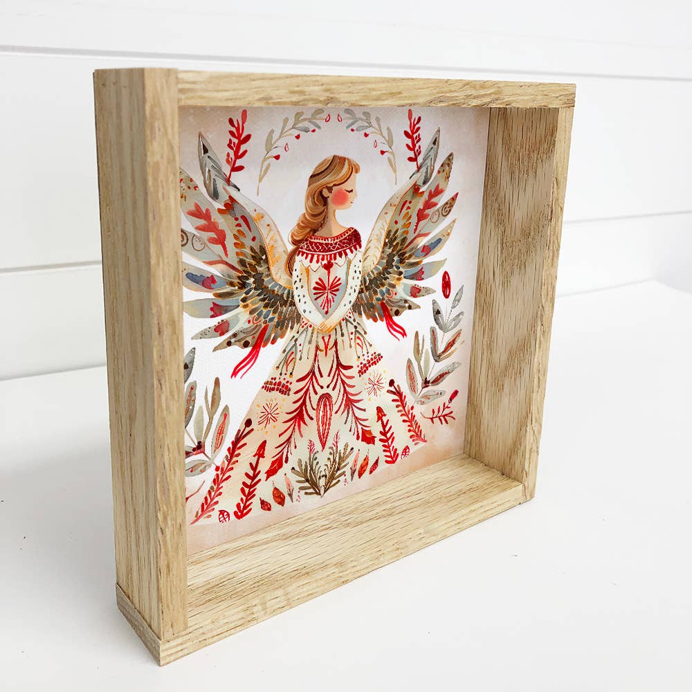 Framed artwork of an angel with floral elements on a white background