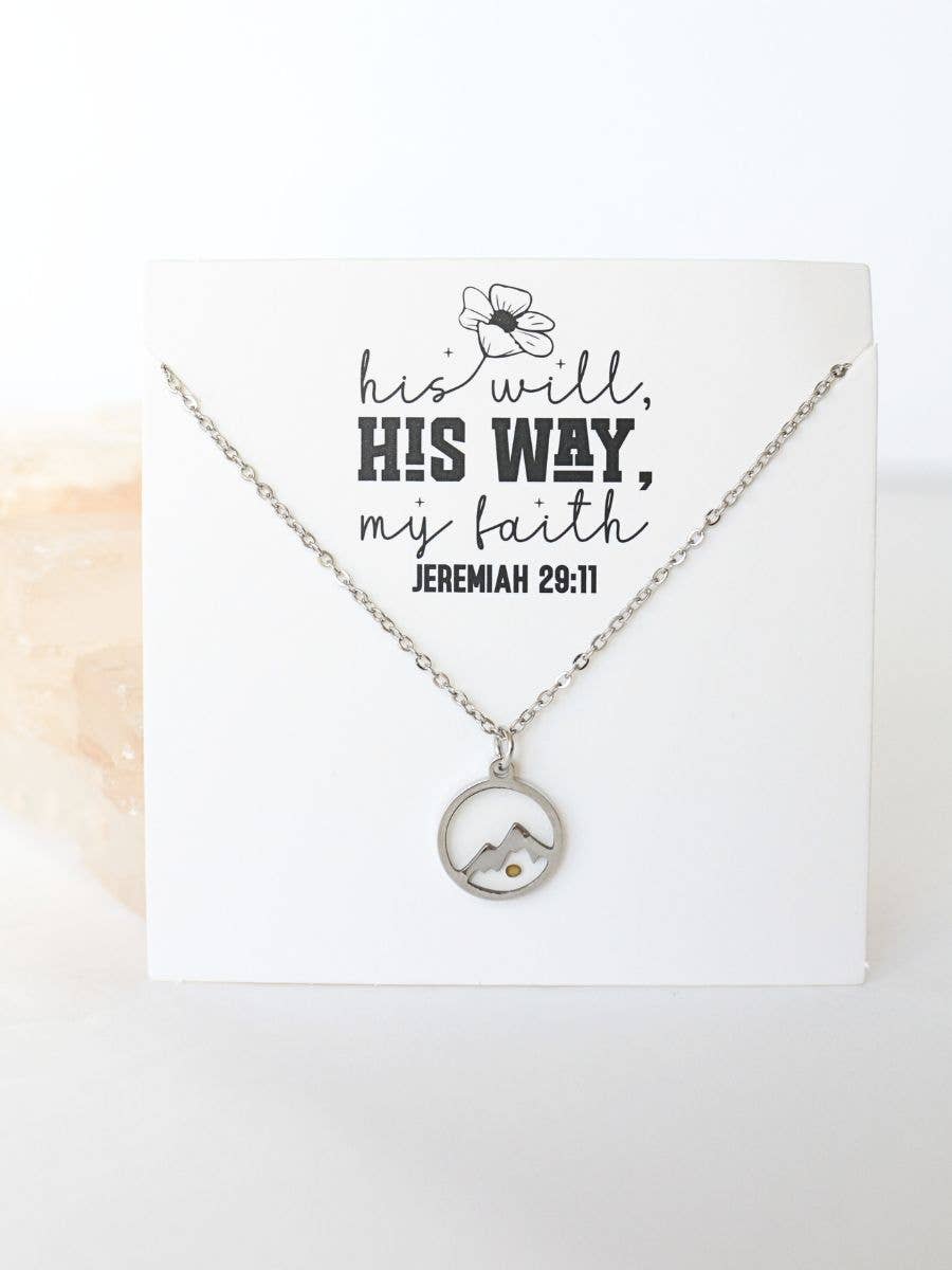 Necklace with a circular pendant on a card with text, displayed on a white background