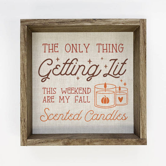 Decorative sign with text about fall scented candles in a wooden frame.