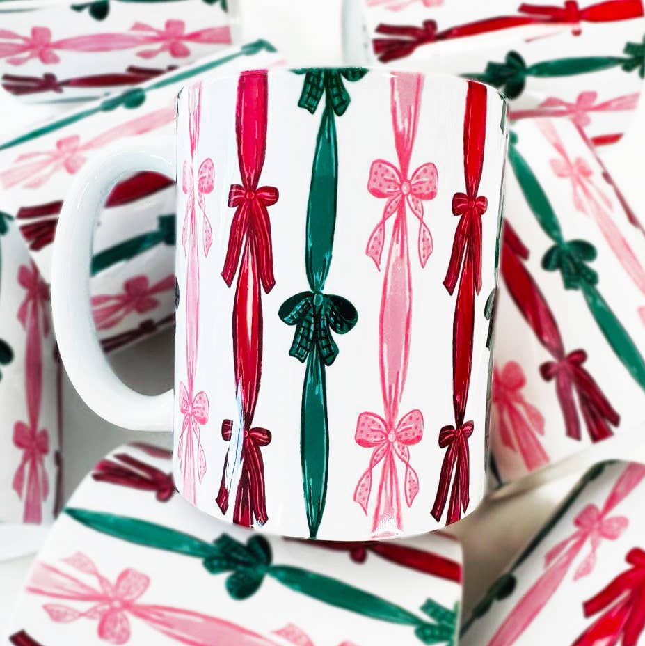 White mug with red and green bows on a white background