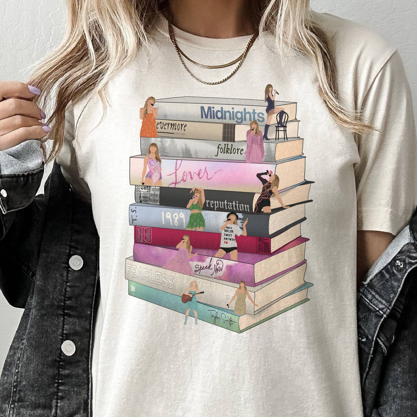A graphic tee with a stack of books print, each representing an album by Taylor Swift.