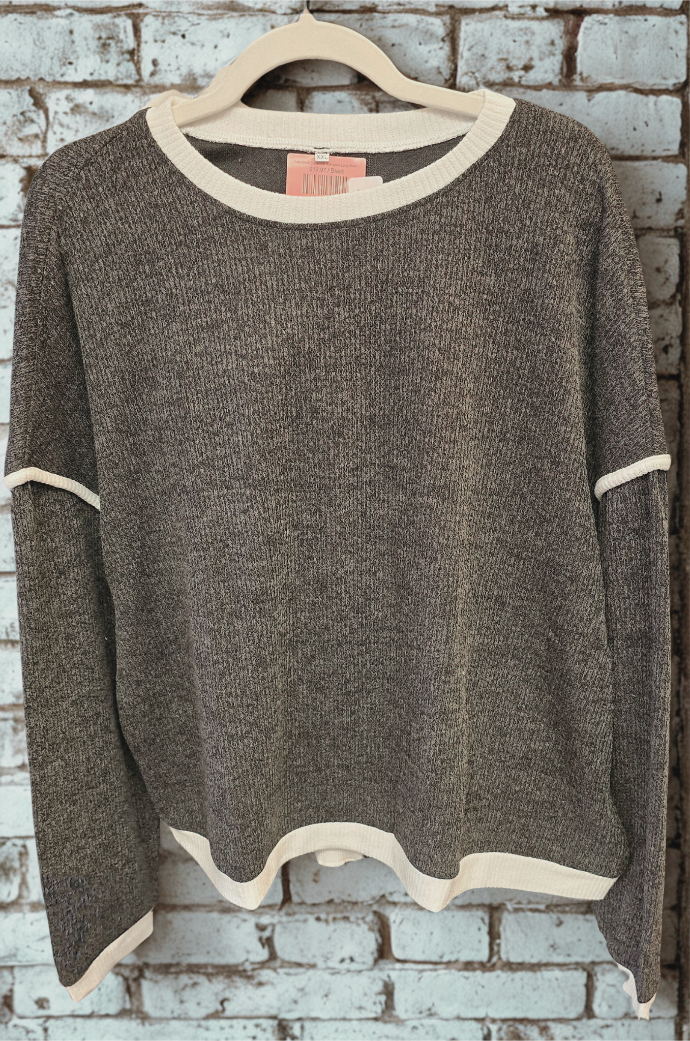 Charcoal sweatshirt against a brick background